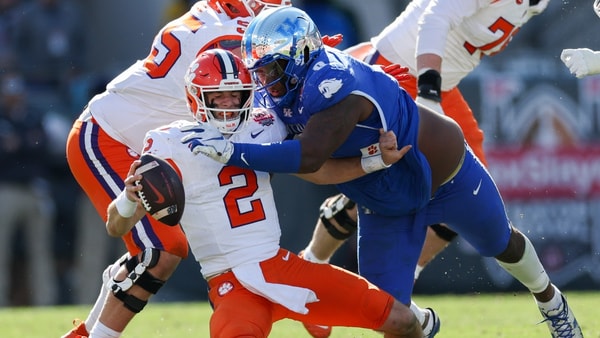 Dec 29, 2023; Jacksonville, FL, USA;  Clemson Tigers quarterback Cade Klubnik (2) is brought down by Kentucky Wildcats defensive lineman Deone Walker (0) in the third quarter during the Gator Bowl at EverBank Stadium. Mandatory Credit: Nathan Ray Seebeck-USA TODAY Sports