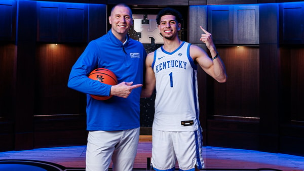 Koby Brea poses with Mark Pope in the Kentucky locker room