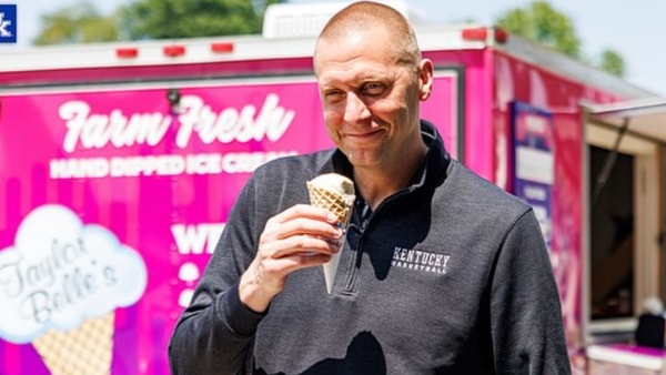 Mark Pope eats ice cream outside the Joe Craft Center