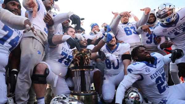 Kentucky holds up the Governor's Cup after beating Louisville - Dr. Michael Huang, Kentucky Sports Radio