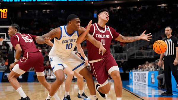Mar 21, 2025; Milwaukee, WI, USA; Kentucky Wildcats forward Brandon Garrison (10) and Troy Trojans forward Victor Valdes (11) battle for control of the ball during the first half at Fiserv Forum. Mandatory Credit: Jeff Hanisch-Imagn Images