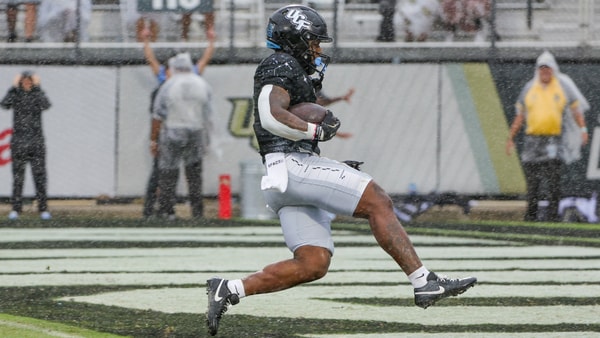Nov 2, 2024; Orlando, Florida, USA; UCF Knights running back RJ Harvey (7) scores a touchdown against the Arizona Wildcats during the first quarter at FBC Mortgage Stadium. Mandatory Credit: Mike Watters-Imagn Images