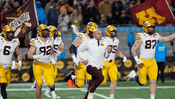 Jan 3, 2025; Charlotte, NC, USA; Minnesota Golden Gophers head coach P.J. Fleck leads his team onto the field during the first quarter against the Virginia Tech Hokies at the DukesÕ Mayo Bowl at Bank of America Stadium. Mandatory Credit: Jim Dedmon-Imagn Images