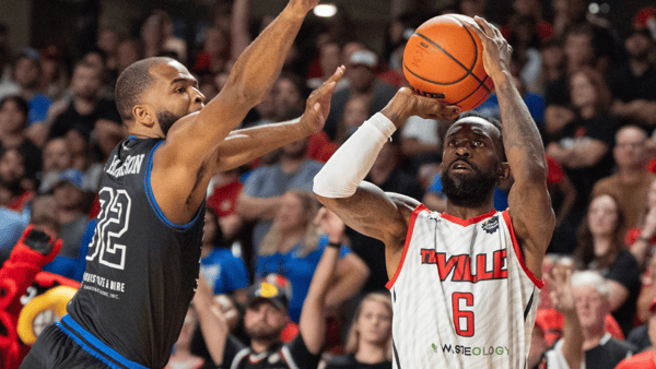Aaron Harrison attempts to block a shot by Russ Smith in the TBT, via Clare Grant:Courier Journal : USA TODAY NETWORK