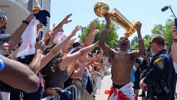 Oklahoma City Thunder guard Shai Gilgeous-Alexander carries the Larry O'Brien trophy as he celebrates with fans as the Oklahoma City Thunder celebrate their first NBA Finals title win with a champions parade throughout downtown Oklahoma City on Tuesday, June 24, 2025. Mandatory Credit: Bryan Terry/USA TODAY NETWORK via Imagn Images