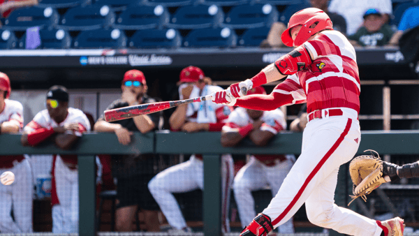 Jun 18, 2025; Omaha, Neb, USA; Louisville Cardinals catcher Tagger Tyson (36) hits a single against the Coastal Carolina Chanticleers during the ninth inning at Charles Schwab Field. Mandatory Credit: Dylan Widger-Imagn Images