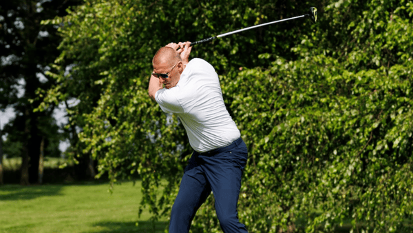 Mark Pope swinging a golf club - Tommy Quarles, UK Athletics