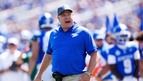 Aug 30, 2025; Lexington, Kentucky, USA; Kentucky Wildcats head coach Mark Stoops discusses a play with a referee during the first quarter against the Toledo Rockets at Kroger Field. Mandatory Credit: Jordan Prather-Imagn Images