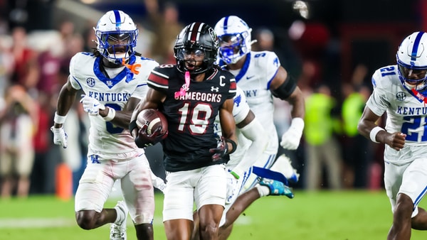 Kentucky defenders try to chase down South Carolina's Vandrevius Jacobs, via Jeff Blake, Imagn Images