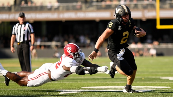 Oct 5, 2024; Nashville, Tennessee, USA; Vanderbilt Commodores quarterback Diego Pavia (2) breaks the tackle of Alabama Crimson Tide defensive lineman LT Overton (22) during the first half at FirstBank Stadium. Mandatory Credit: Steve Roberts-Imagn Images