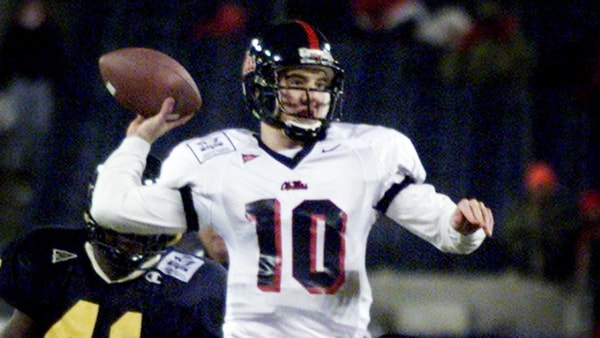 Ole Miss backup quarterback Eli Manning (10) throws a pass under pressure to spark an unsuccessful comeback bid against West Virginia in the Music City Bowl game at Adelphia Coliseum Dec. 28, 2000. West Virginia retiring head coach Don Nehlen won his last game with a 49-38 victory. (© George Walker IV / The Tennessean via Imagn Content Services, LLC_)