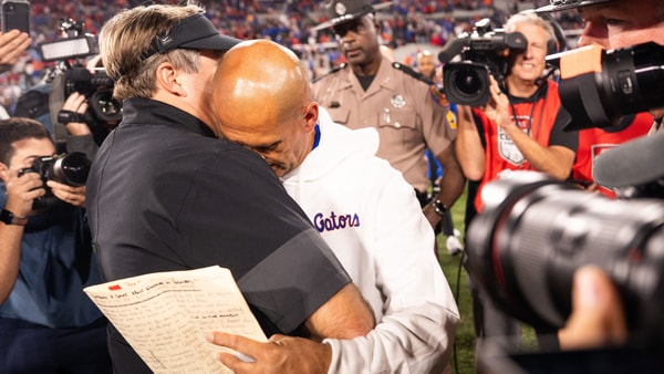 Florida interim head coach Billy Gonzales embraces Kirby Smart after a close loss to Georgia, via © Doug Engle:Florida Times-Union : USA TODAY NETWORK via Imagn Images