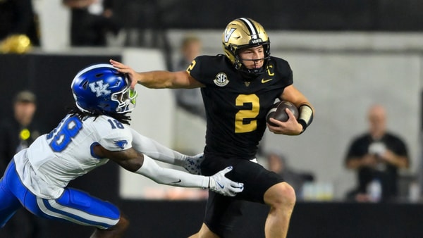 Nov 22, 2025; Nashville, Tennessee, USA; Vanderbilt Commodores quarterback Diego Pavia (2) stiff arms Kentucky Wildcats defensive back Cam Dooley (18) during the second half at FirstBank Stadium. Mandatory Credit: Steve Roberts-Imagn Images