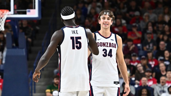 Oct 4, 2025; Spokane, WA, USA; Gonzaga Bulldogs forward Graham Ike (15) and Gonzaga Bulldogs forward Braden Huff (34) meet at center court during Numerica Kraziness in the Kennel at the McCarthey Athletic Center. Mandatory Credit: James Snook-Imagn Images