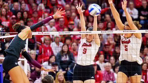 Dec 14, 2025; Lincoln, NE, USA; Texas A&M Aggies outside hitter Kyndal Stowers (37) attacks against Nebraska Cornhuskers opposite hitter Virginia Adriano (9) and middle blocker Rebekah Allick (5) during the fourth set at Bob Devaney Sports Center. Mandatory Credit: Dylan Widger-Imagn Images