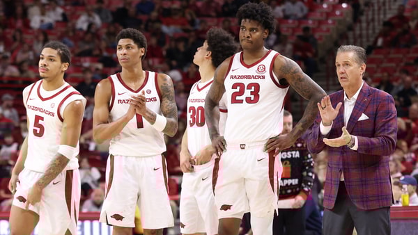 Dec 16, 2025; Fayetteville, Arkansas, USA; Arkansas Razorbacks head coach John Calipari talks to forward Nick Pringle (23), along with guards Meleek Thomas (1) and Darius Acuff Jr (5) during the second half against the Queens Royals at Bud Walton Arena. Arkansas won 108-80. Mandatory Credit: Nelson Chenault-Imagn Images