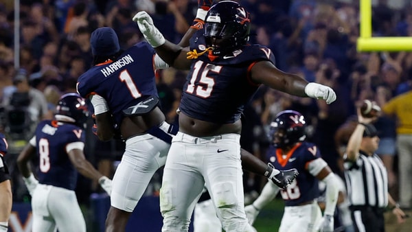 Sep 26, 2025; Charlottesville, Virginia, USA; Virginia Cavaliers defensive lineman Hunter Osborne (15) Cavaliers wide receiver Suderian Harrison (1) celebrate after making a stop on a fourth down against the Florida State Seminoles during the fourth quarter at Scott Stadium. Mandatory Credit: Geoff Burke-Imagn Images