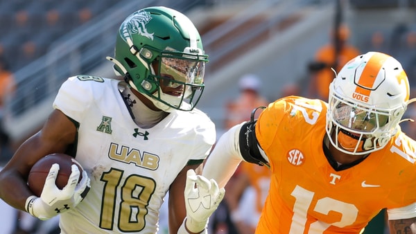 Sep 20, 2025; Knoxville, Tennessee, USA; UAB Blazers wide receiver Xavier Daisy (18) runs the ball against Tennessee Volunteers linebacker Jaedon Harmon (12) during the second half at Neyland Stadium. Mandatory Credit: Randy Sartin-Imagn Images