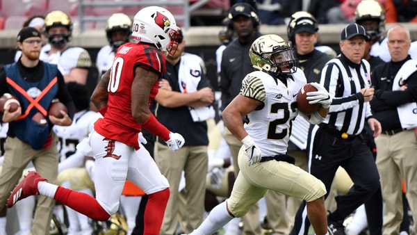 Oct 27, 2018; Louisville, KY, USA; Wake Forest Demon Deacons running back Matt Colburn (22) runs the ball against Louisville Cardinals cornerback Rodjay Burns (10) during the second half at Cardinal Stadium. Wake Forest defeated Louisville 56-35. Mandatory Credit: Jamie Rhodes-Imagn Images