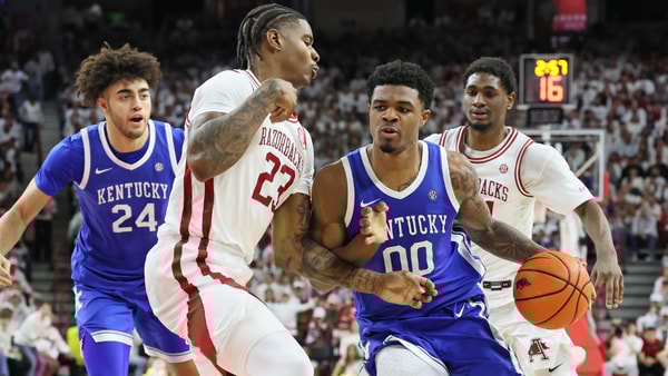 Jan 31, 2026; Fayetteville, Arkansas, USA; Kentucky Wildcats guard Otega Oweh (00) drives against Arkansas Razorbacks forward Nick Pringle (23) during the first half at Bud Walton Arena. Mandatory Credit: Nelson Chenault-Imagn Images