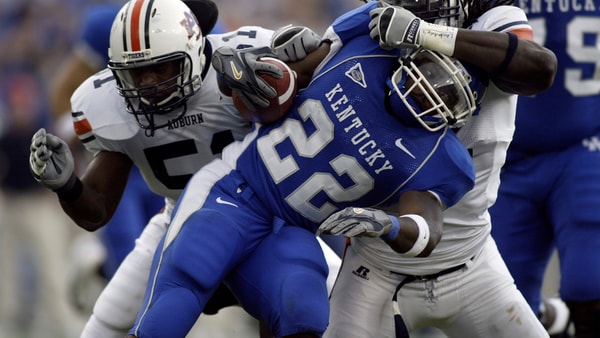Kentucky RB Rafael Little tries to escape a tackle against Auburn in 2005, via John Reed-Imagn Images