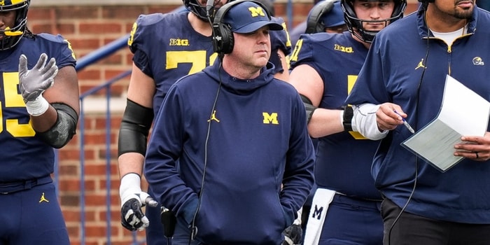 Michigan offensive coordinator Chip Lindsey, left, and offensive line coach Grant Newsome watch warm up before the spring game at Michigan Stadium in Ann Arbor on Saturday, April 19, 2025.