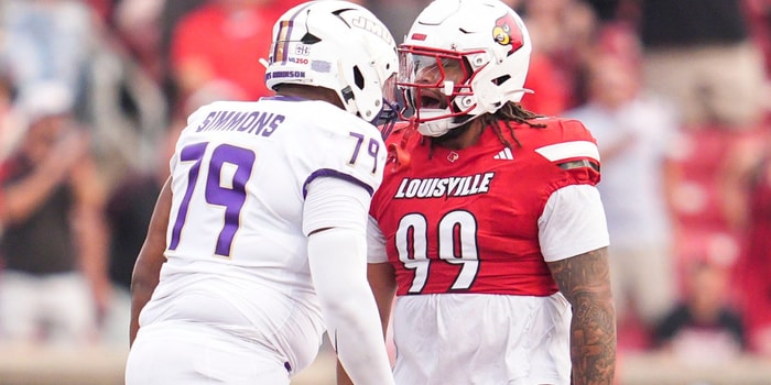 Louisville Cardinals defensive lineman Jordan Guerad (99) has words with James Madison Dukes offensive lineman Joseph Simmons (79) in the first half during the Louisville-James Madison college football game Friday September 5, 2025 at L&N Credit Union Stadium in Louisville, Kentucky.