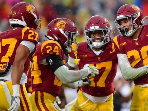 USC Trojans cornerback Alex Graham (27) safety Christian Pierce (24) cornerback Decarlos Nicholson (17) and safety Kennedy Urlacher (28) celebrate after Iowa Hawkeyes turn the ball over on fourth down during the second half at the Los Angeles Memorial Coliseum
