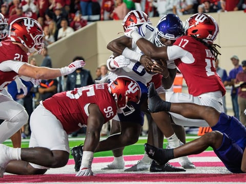 Indiana's Tyrique Tucker (95), Rolijah Hardy (5) and Daniel Ndukwe (17) tackle Northwestern's Aiden Chiles (0) for a safety
