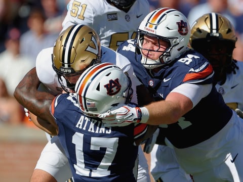 Xavier Atkins and Cody Sigler combine for a tackle against Vanderbilt. (Photo by USA Today Network)