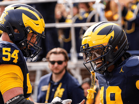 Michigan Wolverines football offensive lineman Andrew Sprague and quarterback Bryce Underwood celebrate after a touchdown in a 63-3 win over Central Michigan. (Photo by Junfu Han / USA TODAY NETWORK via Imagn Images)