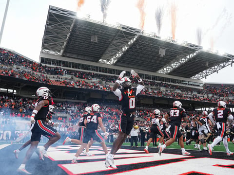 Oregon State players run onto the field before facing Texas Tech during an NCAA football game at Reser Stadium on Saturday,