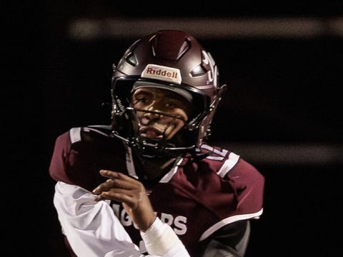 Appoquinimink quarterback Desai Drummond releases a pass as Caravel defensive end Isaac Chukwurah chases in the Jaguars 28-21