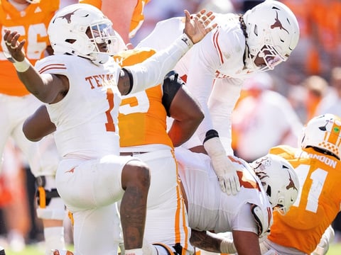 Texas edge Colin Simmons (1) celebrates after Tennessee quarterback Faizon Brandon (11) is sacked again during a college