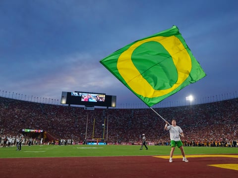 An Oregon cheerleader celebrates a touchdown as the Oregon Ducks face the USC Trojans on Sept. 26, 2026, at Los Angeles Memorial
