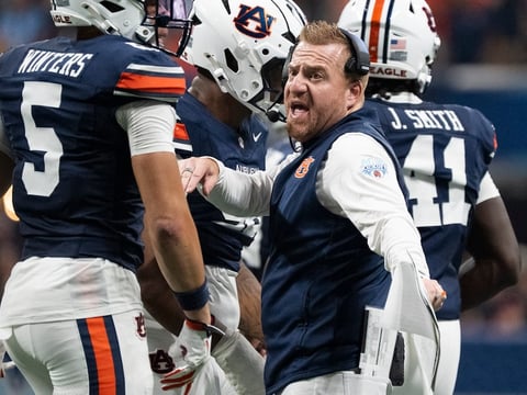 Auburn Tigers head coach Alex Golesh talks with his team as Auburn Tigers take on Baylor Bears in the Aflac Kickoff Game at