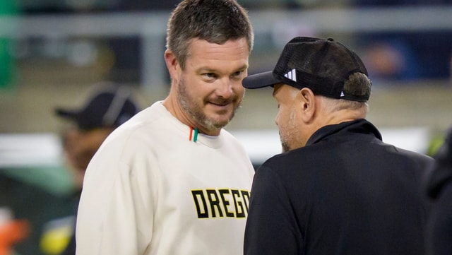 Oregon Ducks head coach Dan Lanning, left, talks with Nebraska Cornhuskers head coach Matt Rhule before the game as the Oregon