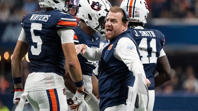 Auburn Tigers head coach Alex Golesh talks with his team as Auburn Tigers take on Baylor Bears in the Aflac Kickoff Game at
