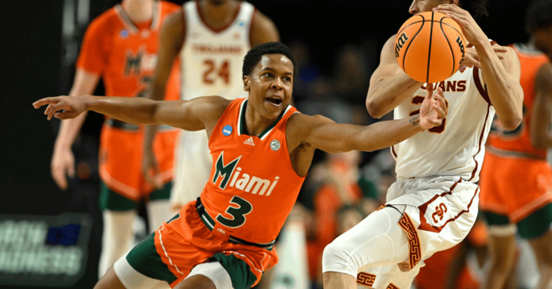 Charlie Moore #3 of the Miami (Fl) Hurricanes defends against Max Agbonkpolo #23 of the USC Trojans during the first half in the first round game of the 2022 NCAA Men's Basketball Tournament at Bon Secours Wellness Arena on March 18, 2022 in Greenville, S