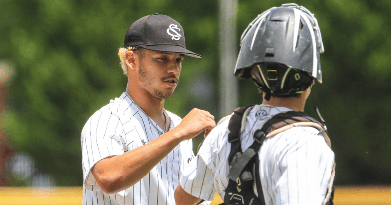 Noah Hall fist bumps a catcher during an outing