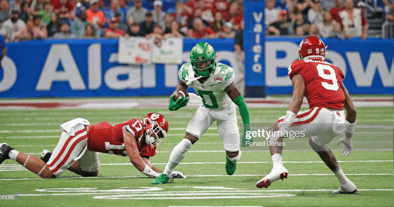 SAN ANTONIO, TX - DECEMBER 29: Seven McGee #0 of the Oregon Ducks looks for running room against the Oklahoma Sooners in the Valero Alamo Bowl at the Alamodome on December 29, 2021 in San Antonio, Texas. (Photo by Ronald Cortes/Getty Images)