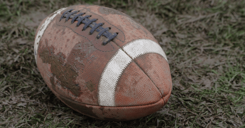 muddy football stock photo