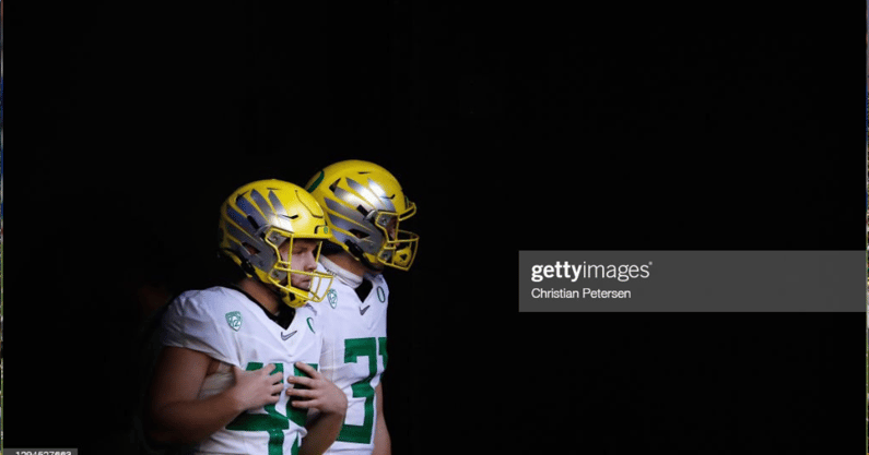 GLENDALE, ARIZONA - JANUARY 02: Place kicker Camden Lewis #49 and punter Race Mahlum #31 of the Oregon Ducks walk onto the field before PlayStation Fiesta Bowl against the Iowa State Cyclones at State Farm Stadium on January 02, 2021 in Glendale, Arizona.