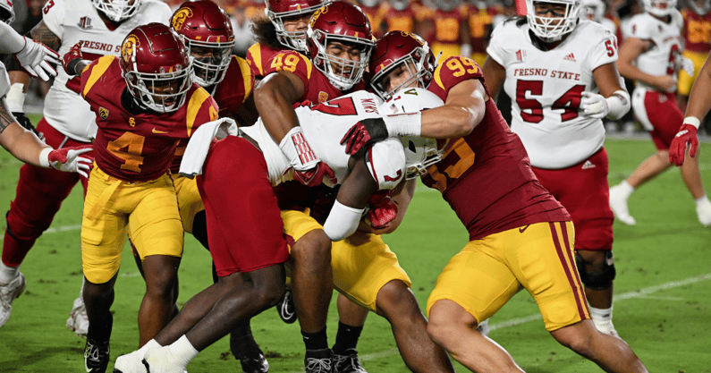 USC Trojans defensive lineman Tuli Tuipulotu (49) and Nick Figueroa (99) tackle Fresno State Bulldogs running back Jordan Mims (7) in the first half of an NCAA football game against the Bulldogs played on September 17, 2022 at the Los Angeles Memorial Col