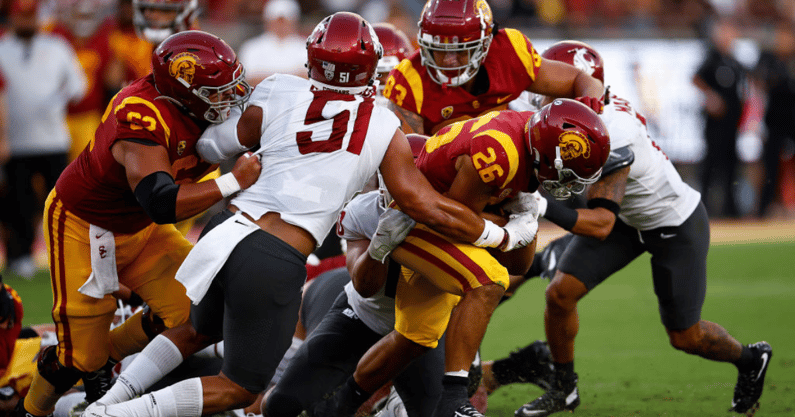 Travis Dye #26 of the USC Trojans runs the ball against the Washington State Cougars in the second quarter at United Airlines Field at the Los Angeles Memorial Coliseum on October 08, 2022 in Los Angeles, California. (Photo by Ronald Martinez/Getty Images