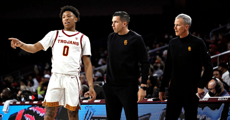 Boogie Ellis #0 of the USC Trojans talks with Associate Head Coach Chris Capko, center, and head coach Andy Enfield of the USC Trojans in the second half of a NCAA basketball game at the Galen Center in Los Angeles on Thursday, February 17, 2022. USC Troj