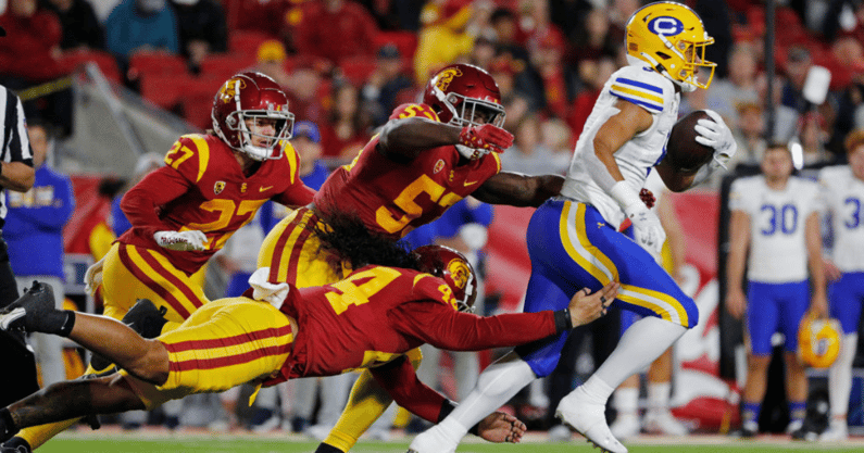 USC Trojans linebacker Tuasivi Nomura (44), USC Trojans linebacker Shane Lee (53) and USC Trojans defensive back Bryson Shaw (27) go after California Golden Bears running back Jaydn Ott (6) in the first half at the Coliseum on November 5, 2022 in Los Ange