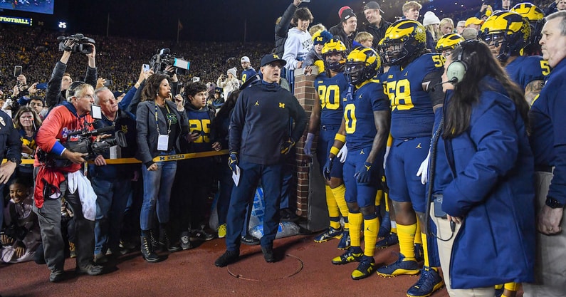 Michigan head coach Jim Harbaugh and his team