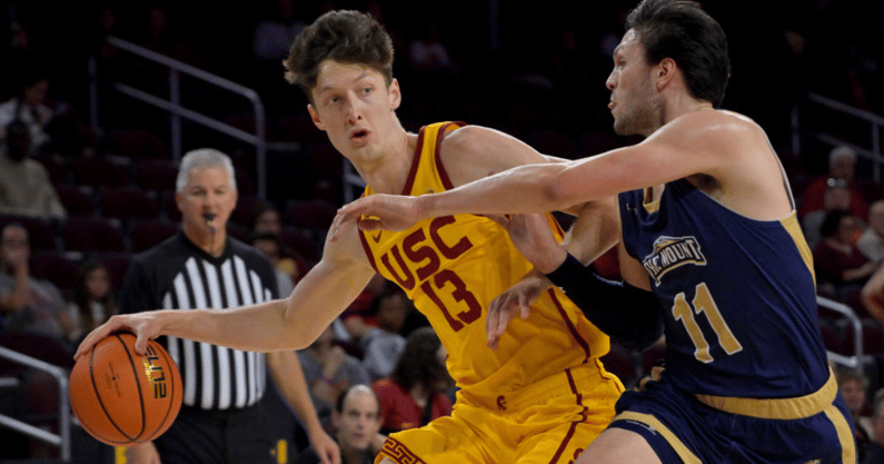 Drew Peterson #13 of the USC Trojans is defended by George Tinsley #11 of the Mount St. Mary's Mountaineers as he drives to the basket at Galen Center on November 18, 2022 in Los Angeles, California. (Photo by Jayne Kamin-Oncea/Getty Images)