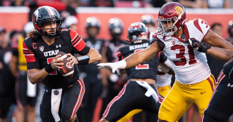 Cameron Rising #7 of the Utah Utes rushes the ball away from Tyrone Taleni #31of the USC Trojans during the first half of their game October 15, 2022 Rice-Eccles Stadium in Salt Lake City Utah. (Photo by Chris Gardner/ Getty Images)